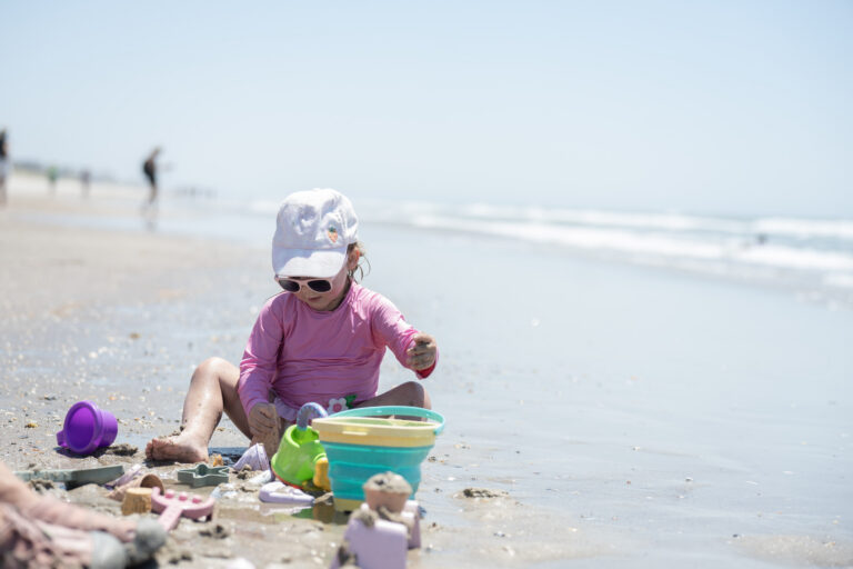 Kid playing in the sand on the beach