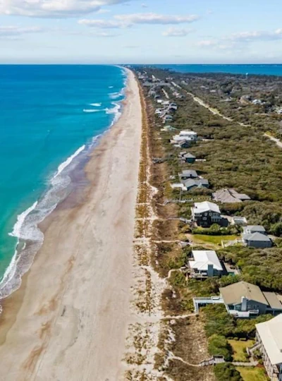 a high altitude drone shot of the crystal coast oceanfront shoreline beach, stretching for miles